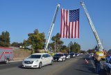 The Lemoore Volunteer Fire Department displayed its American flag across Cinnamon Avenue as local law enforcement agencies escorted slain Officer Jonathan Diaz's hearse through Lemoore Wednesday afternoon.